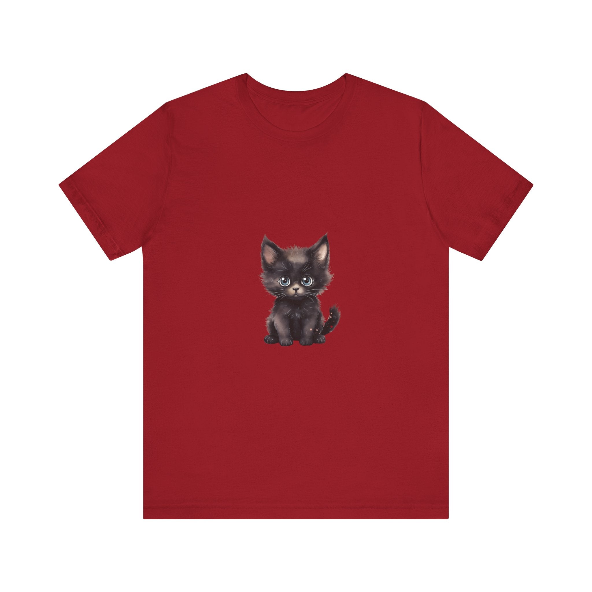 A fluffy white and grey kitten with striking blue eyes wearing a t-shirt with a cute design