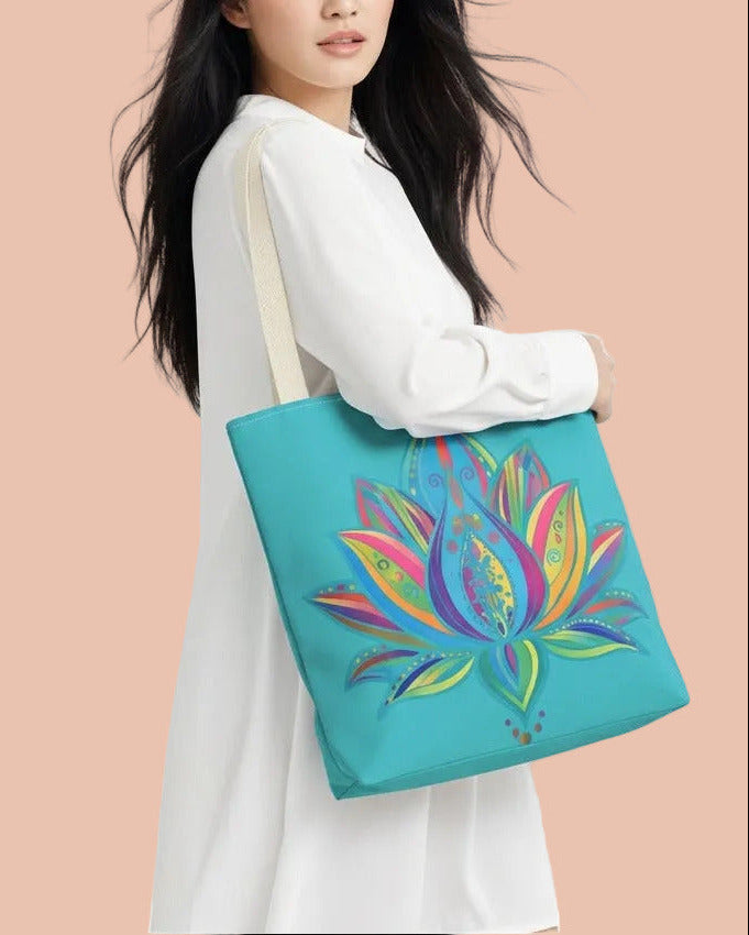 A woman in a white long-sleeve dress carries a turquoise tote bag featuring a colorful, stylized lotus flower design. The background is a soft, abstract swirl pattern in pastel pink, blue, and purple.