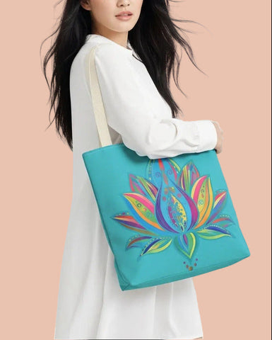 A woman in a white long-sleeve dress carries a turquoise tote bag featuring a colorful, stylized lotus flower design. The background is a soft, abstract swirl pattern in pastel pink, blue, and purple.