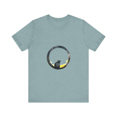 A black cat with a mischievous expression sits under a crescent moon on a whimsical style tee shirt