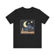 A black t-shirt with a sleepy cat design against a moonlit night background