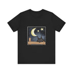 A black t-shirt with a sleepy cat design against a moonlit night background