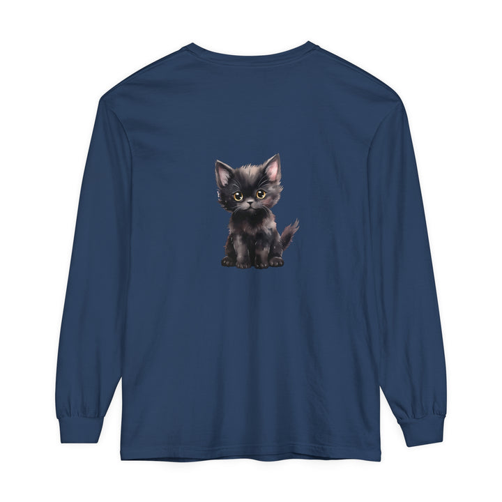 A cute black kitten with striking yellow eyes on a long sleeve t-shirt