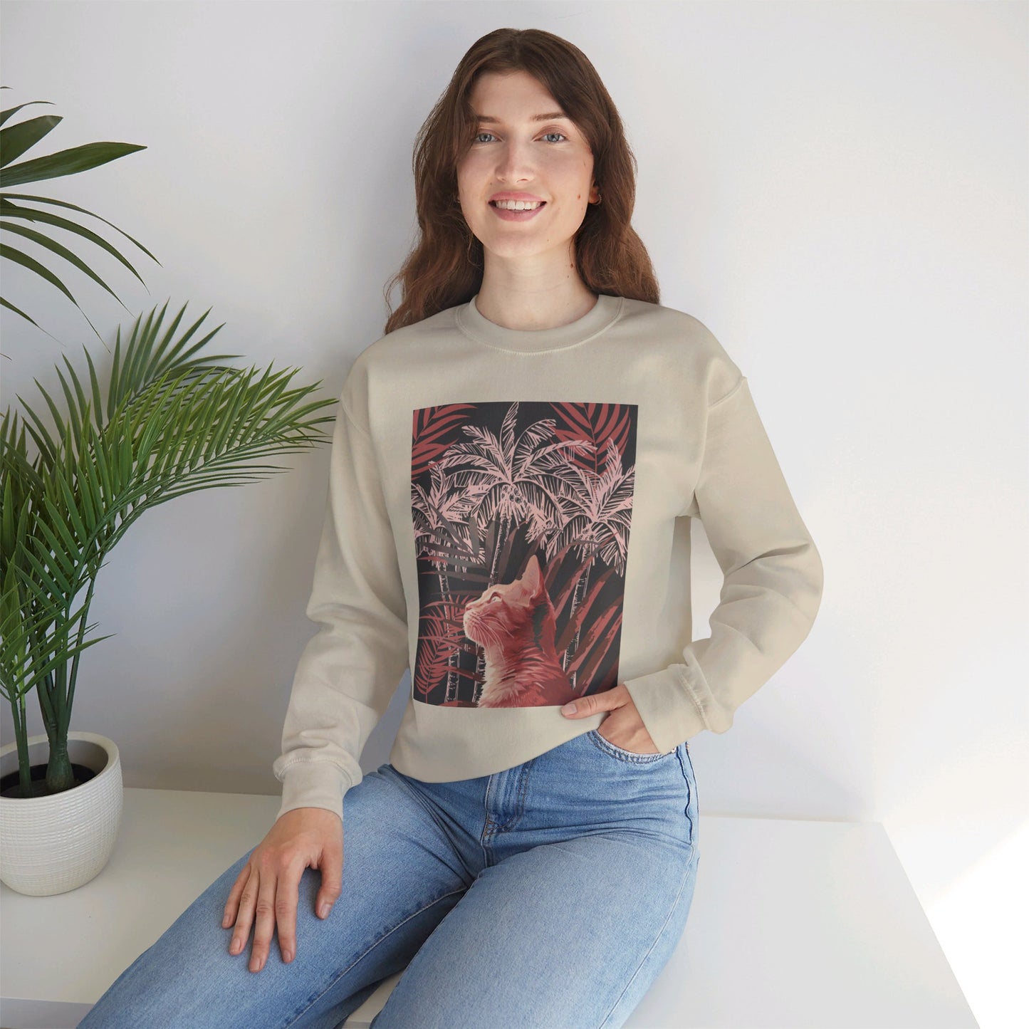 A cozy unisex heavy blend crewneck sweatshirt featuring a cute cat lounging under palm trees