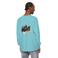 A watercolor illustration of a black cat peacefully sleeping on a t-shirt