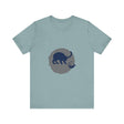 A black cat with glowing eyes stands against a full moon, creating a mysterious and playful silhouette on a t-shirt