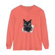 A close-up image of a black cat portrait printed on a unisex long sleeve t-shirt