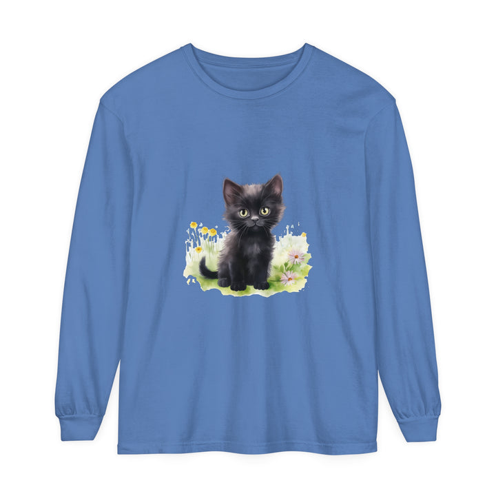 A cute black kitten exploring a vibrant flower garden on a long sleeve t-shirt