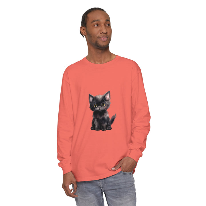 Adorable black kitten with striking yellow eyes on a long sleeve t-shirt