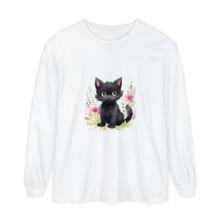 A white t-shirt featuring a watercolor illustration of a playful kitten surrounded by colorful flowers and foliage