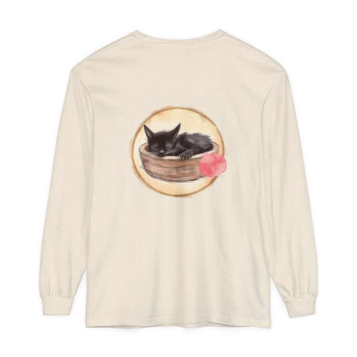 A watercolor illustration of a sleeping cat curled up inside a bowl on a long sleeve t-shirt