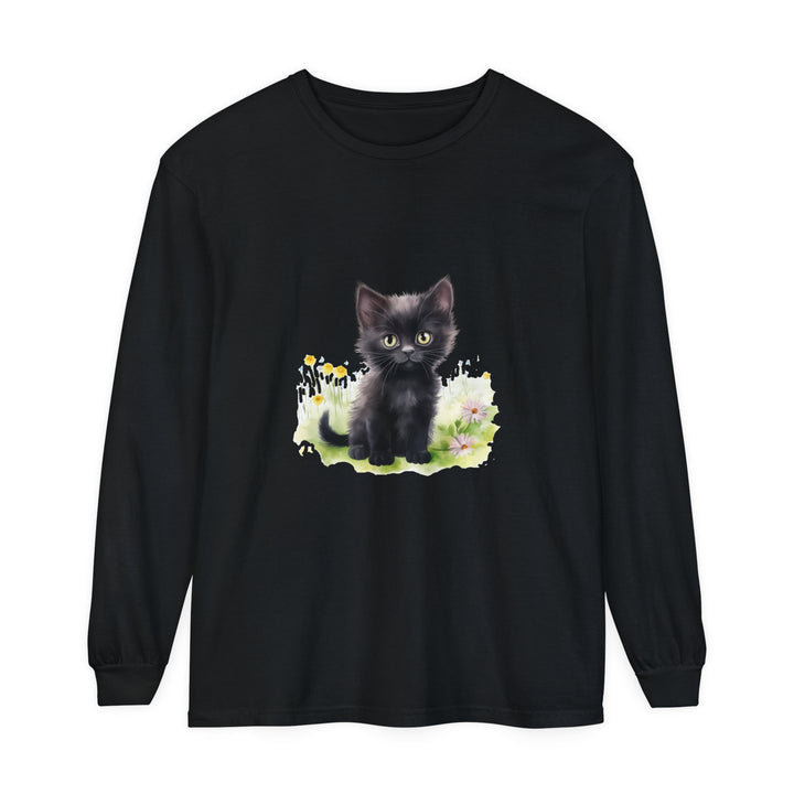 Black kitten sitting in a colorful flower garden, wearing a long sleeve T-shirt with a cute design