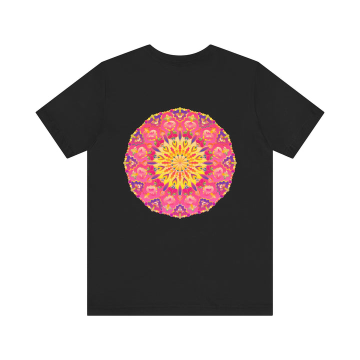 A vibrant and intricately designed mandala t-shirt in pink and yellow representing peace and harmony