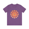 A colorful, vibrant mandala tee in shades of pink, yellow, orange, and green