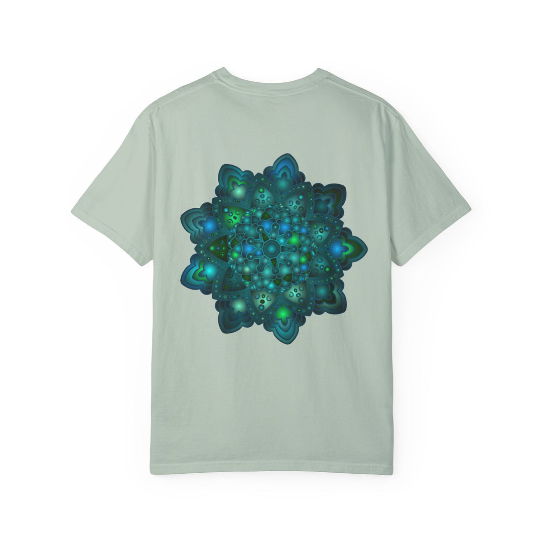 A close-up image of an intricate blue and green mandala design on a unisex t-shirt