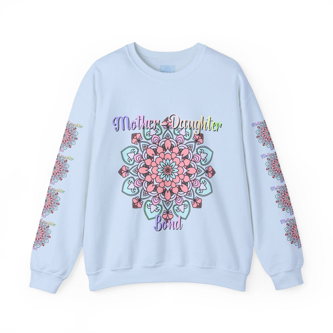 Mother and daughter sitting together, wearing matching 'Mother-Daughter Bond' Unisex Heavy Blend™ Crewneck Sweatshirts, the perfect birthday gift for Mom