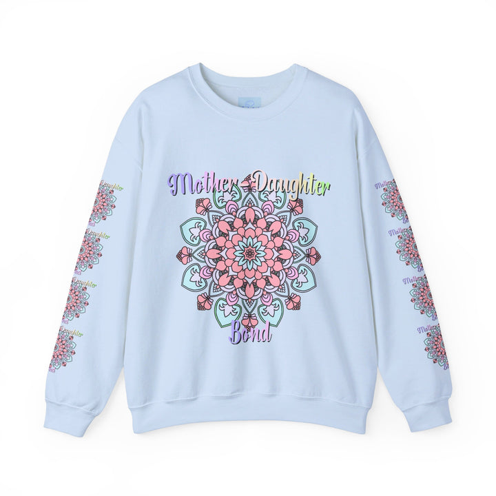 Mother and daughter sitting together, wearing matching 'Mother-Daughter Bond' Unisex Heavy Blend™ Crewneck Sweatshirts, the perfect birthday gift for Mom