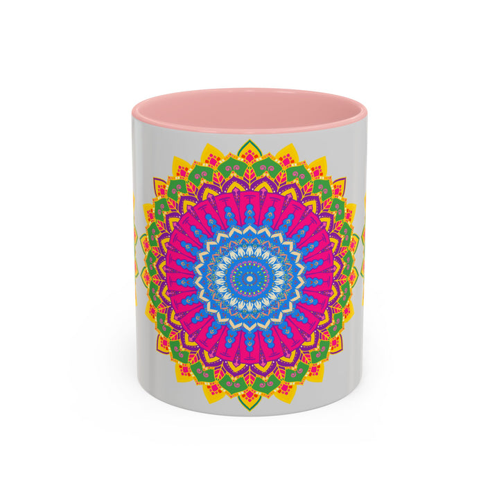 A colorful ceramic mug with a geometric mandala art design in vibrant shades of blue, red, and yellow