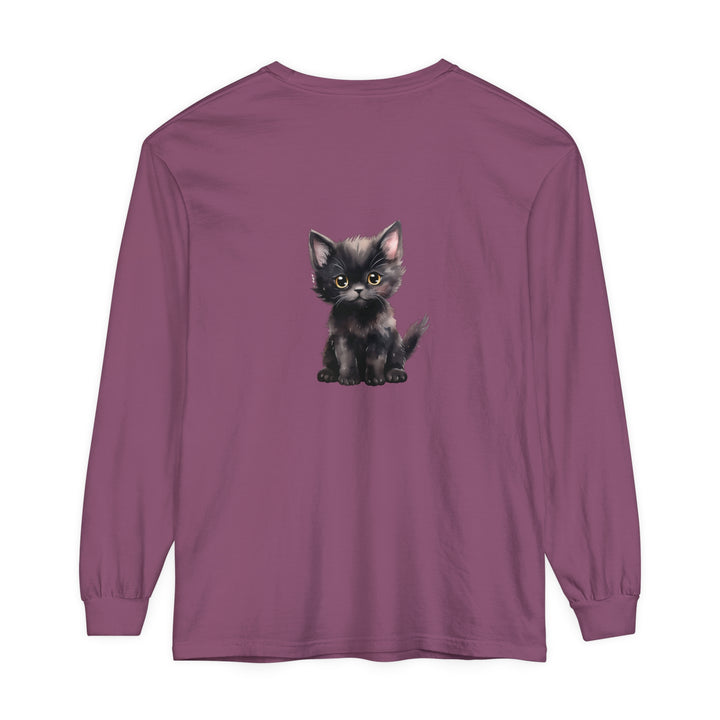 A close-up image of a cute black kitten with striking yellow eyes printed on a long sleeve t-shirt