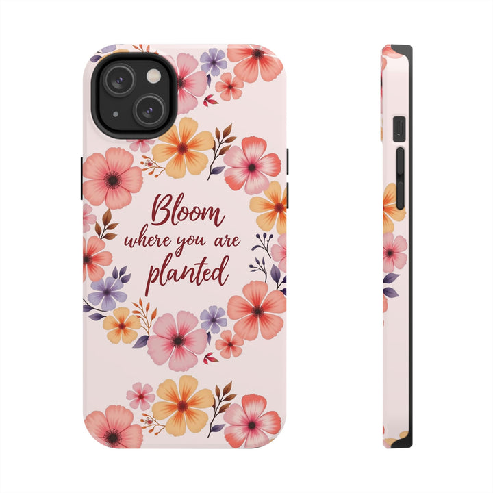 Light pink phone case with a beautiful flower garland design that reads 'Bloom where you are planted'