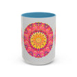 Colorful mug featuring intricate mandala art in shades of pink, yellow, and green