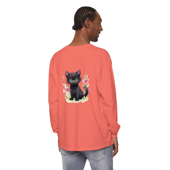 A cute and playful kitten surrounded by vibrant floral watercolor designs on a t-shirt