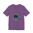 A black cat with glowing eyes and arched back, on a t-shirt, against a mysterious backdrop