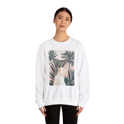 A cozy unisex heavy blend crewneck sweatshirt featuring a cute cat relaxing under palm trees design