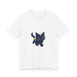 A black cat with bright green eyes, wearing a playful expression, sprawled across a cozy mystery-themed t-shirt