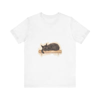A watercolor illustration of a black cat peacefully sleeping on a t-shirt