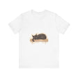 A watercolor illustration of a black cat peacefully sleeping on a t-shirt