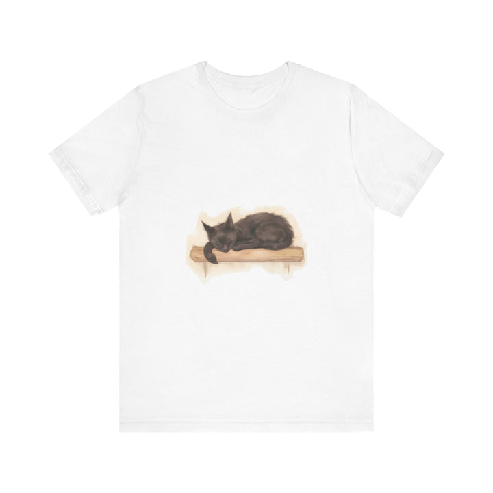 A watercolor illustration of a black cat peacefully sleeping on a t-shirt