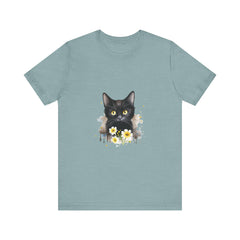 A close-up image of a black cat with piercing yellow eyes printed on a t-shirt