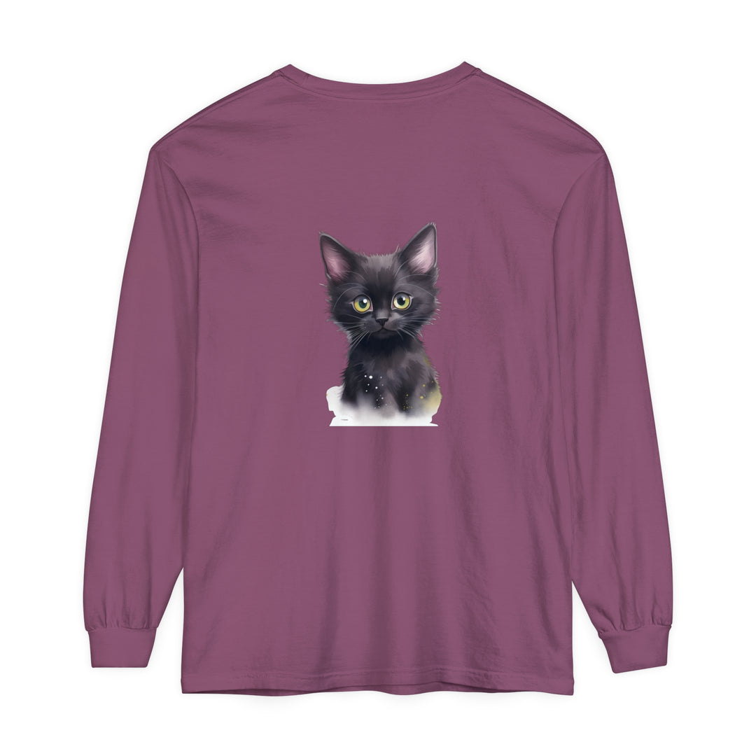 A charming black kitten with bright green eyes sits on a soft, comfortable T-shirt, making it an adorable and stylish addition to any wardrobe