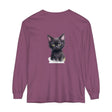 A charming black kitten with bright green eyes sits on a soft, comfortable T-shirt, making it an adorable and stylish addition to any wardrobe