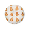 A round floor cushion with a repeating pattern of cute orange tabby cartoon cats on an off-white background, shown against a plain white studio backdrop.