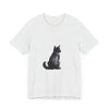 A black cat with glowing green eyes sits against a moonlit background on a Black Cat Mystery t-shirt, a perfect addition for any cat lover's wardrobe