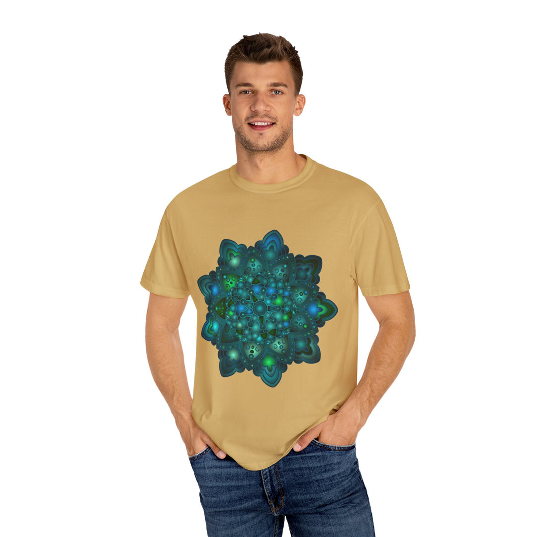 A close-up image of an intricate blue and green mandala design on a comfortable unisex t-shirt