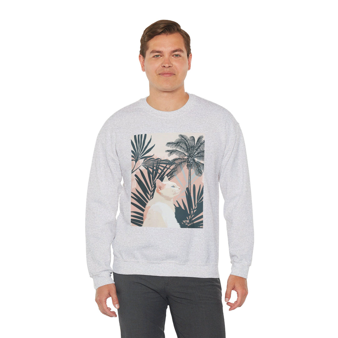 A cozy unisex heavy blend crewneck sweatshirt with a cute cat lounging under palm trees design