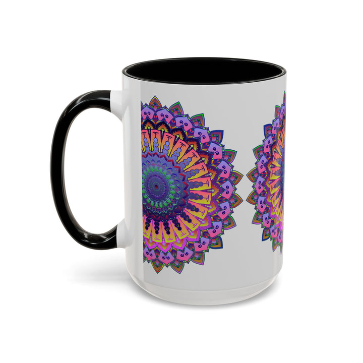 A grey ceramic mug with a vibrant mandala design in red, blue, and yellow