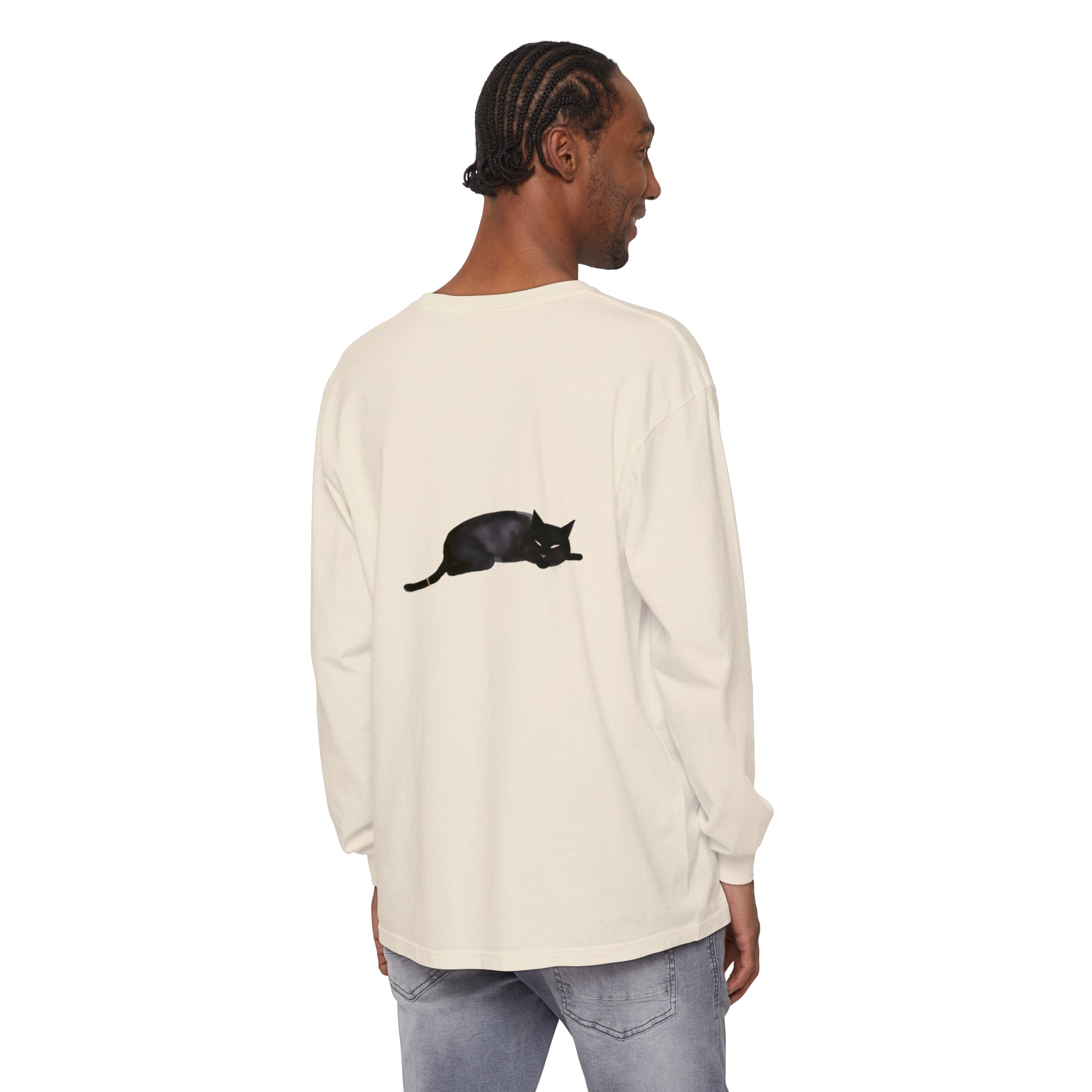 A black cat laying peacefully on a comfortable long sleeve t-shirt