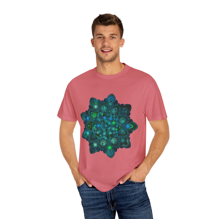 A close-up image of an intricate blue and green mandala design on a unisex t-shirt