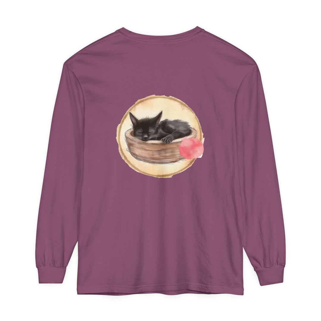 A long sleeve t-shirt featuring a watercolor illustration of a sleeping cat in a bowl