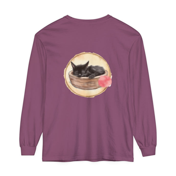 A long sleeve t-shirt featuring a watercolor illustration of a sleeping cat in a bowl