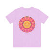 A vibrant pink and yellow mandala design adorns this T-shirt, symbolizing peace and harmony