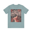 A cute ginger cat sitting under a palm tree on a tee