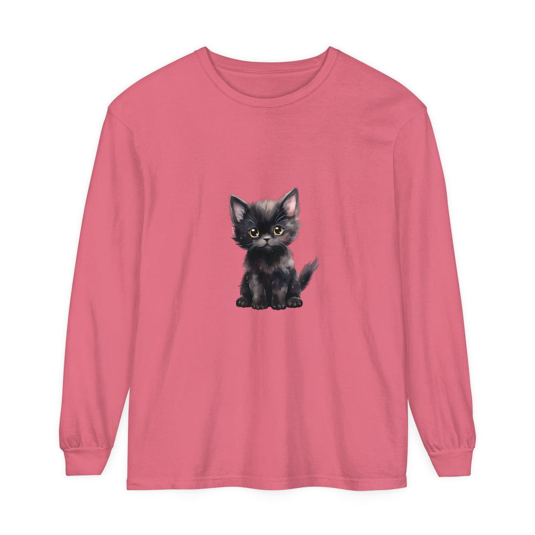 A cute and playful black kitten with striking yellow eyes on a comfortable long sleeve t-shirt