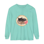 A watercolor illustration of a cute sleeping cat in a bowl, printed on a long sleeve t-shirt