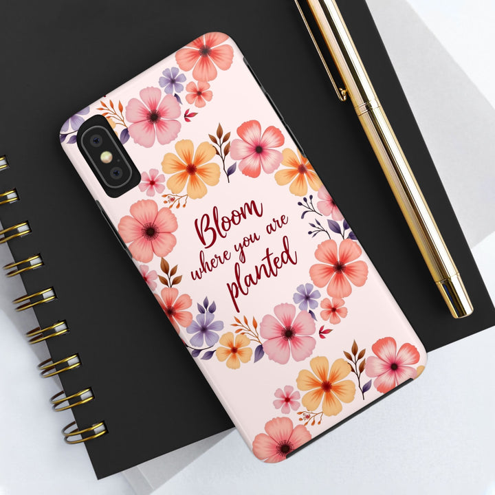 A light pink phone case with a flower garland design, inspired by the idea of blooming where you are planted