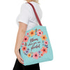 Three sizes of floral tote bag featuring the phrase 'Bloom Where You Are Planted' in bold, vibrant colors